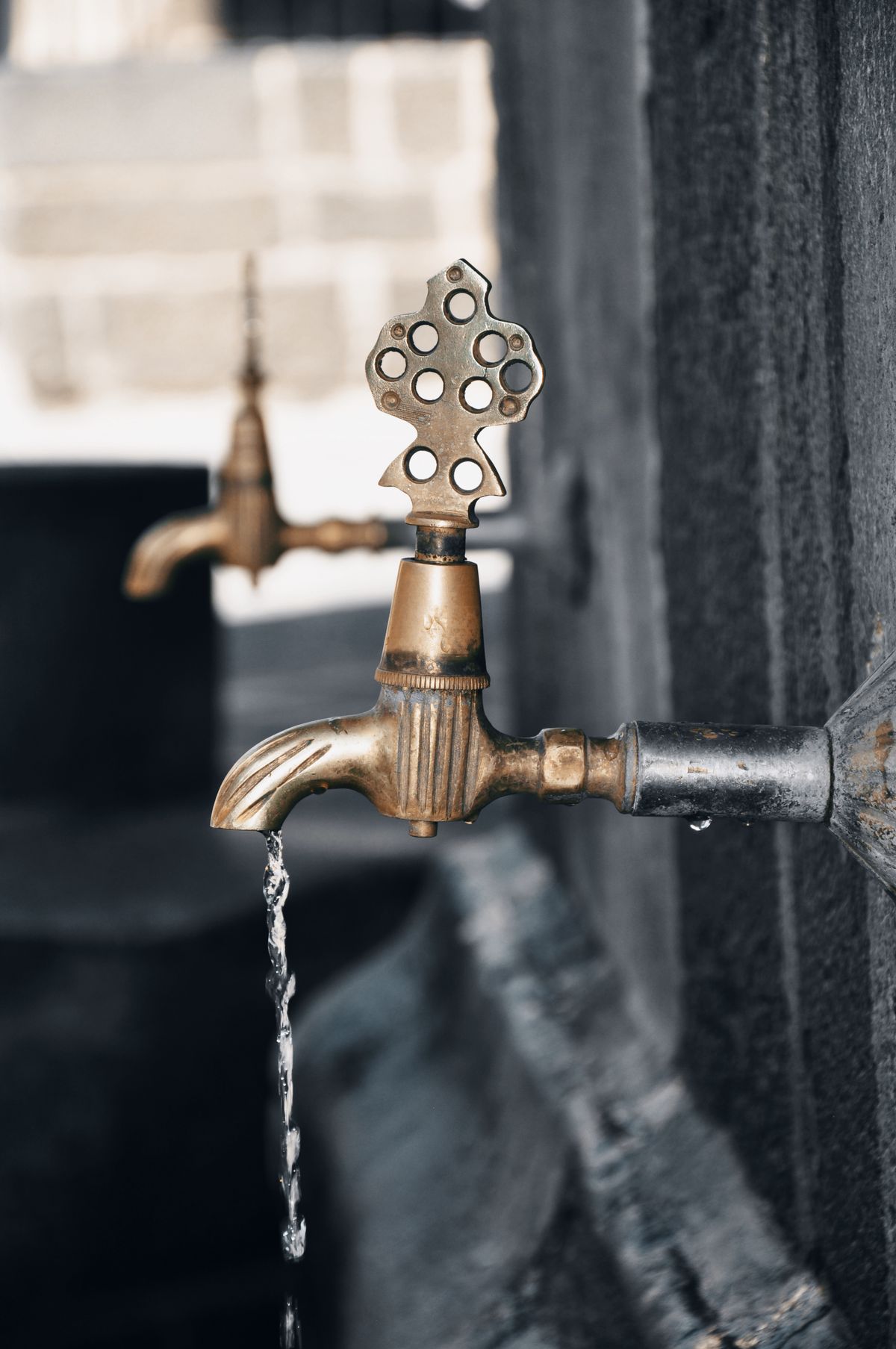Water running from a brass faucet where a rotten egg sulfur smell is often first noticed in a Jacksonville home