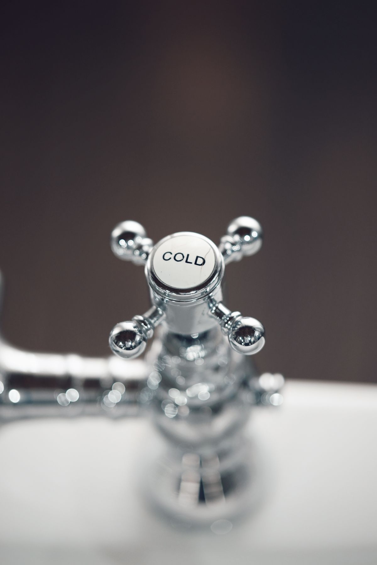 Close-up of water running from a chrome household faucet in a Jacksonville home