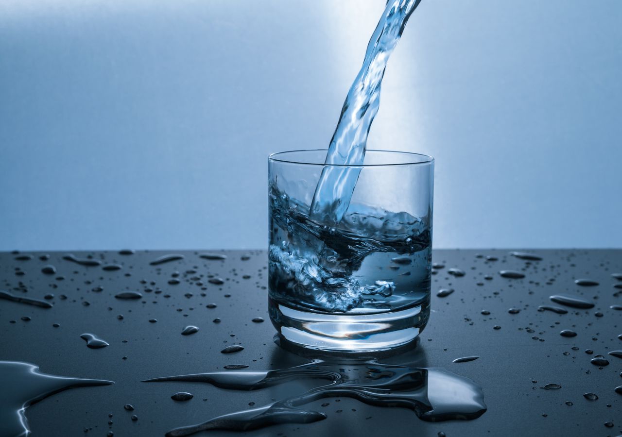 Clean, filtered water being poured into a glass — bottled-water taste from a Kenai FreshStream RO system