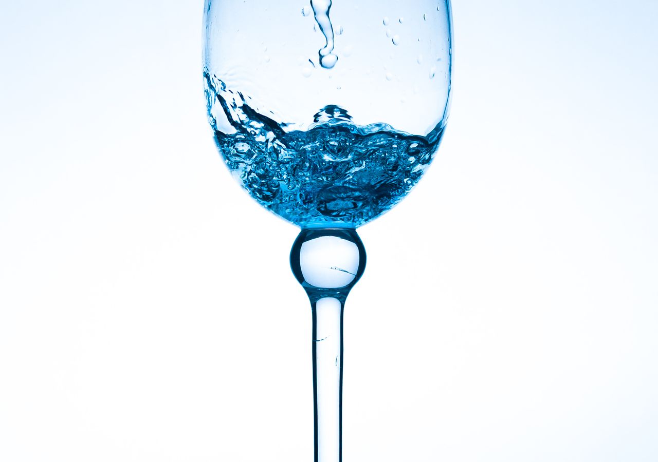 Crystal-clear treated water in a glass — the result of Kenai EnviroPro salt-free scale reduction