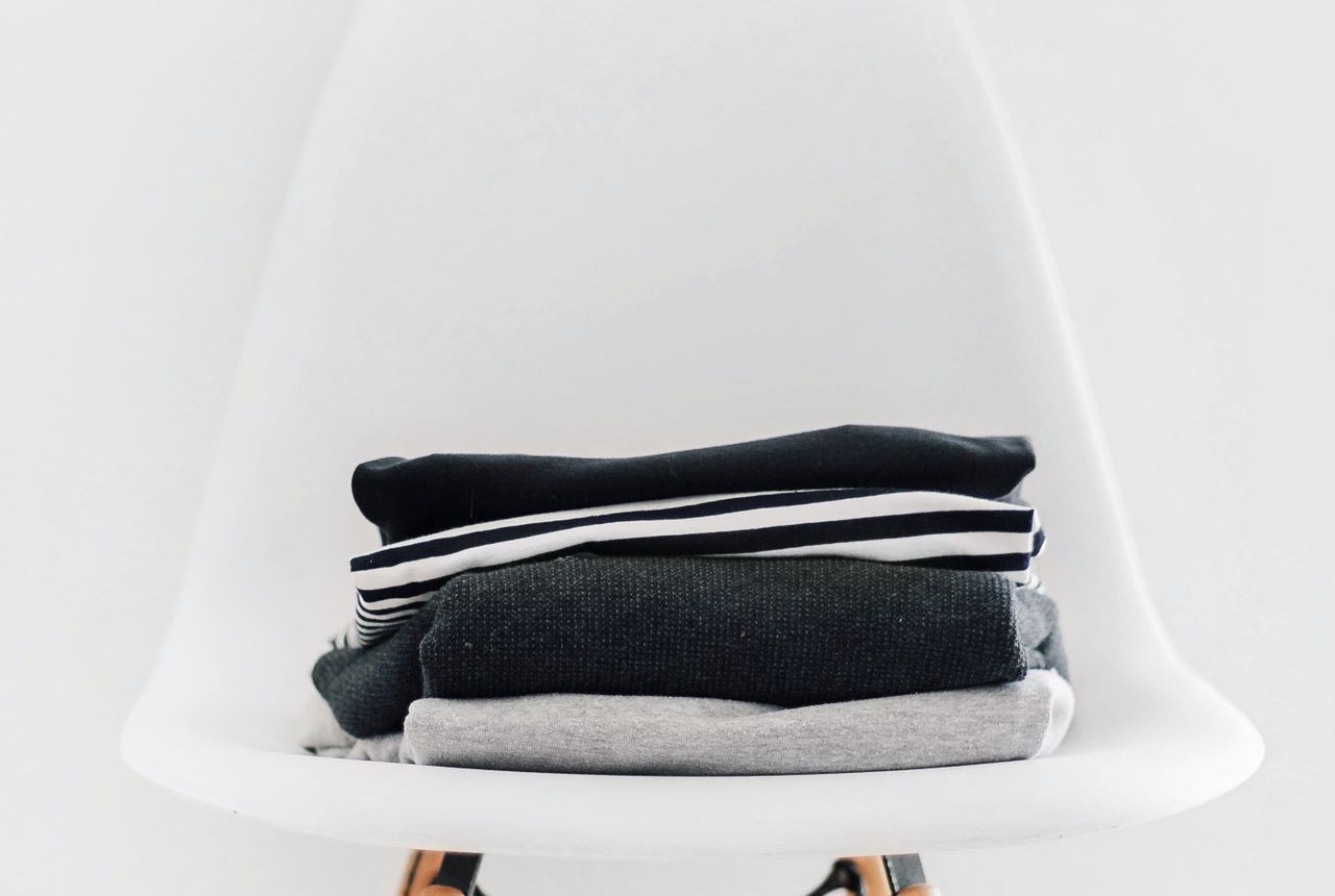 A neat stack of clean folded clothes — iron- and odor-free water keeps laundry whiter and brighter
