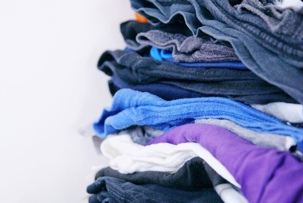 A neat stack of clean, soft folded laundry — soft water keeps clothes softer, brighter and longer-lasting