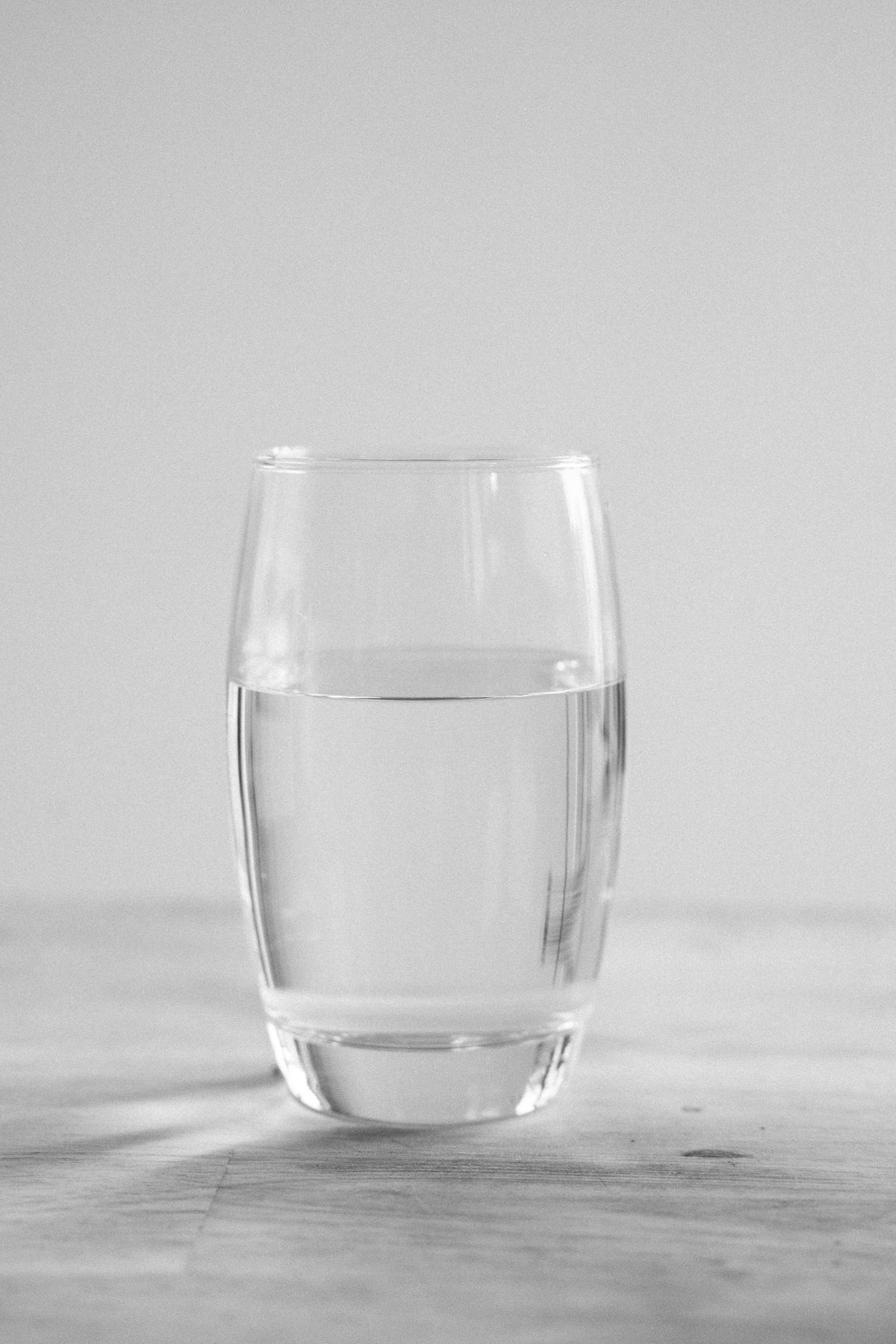 Glass of clean, clear filtered water against a bright background