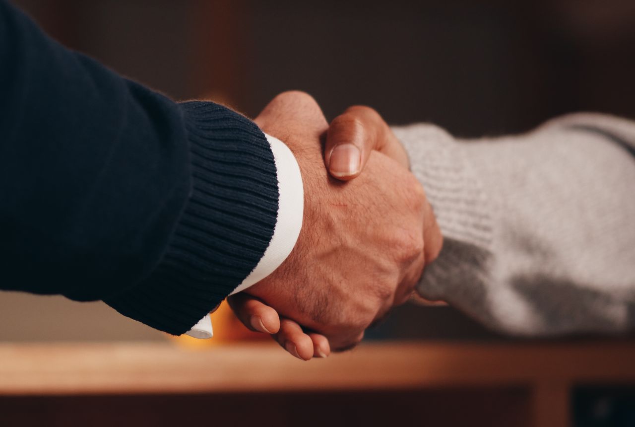 A handshake representing Waterboy's money-back guarantee on every whole-home installation