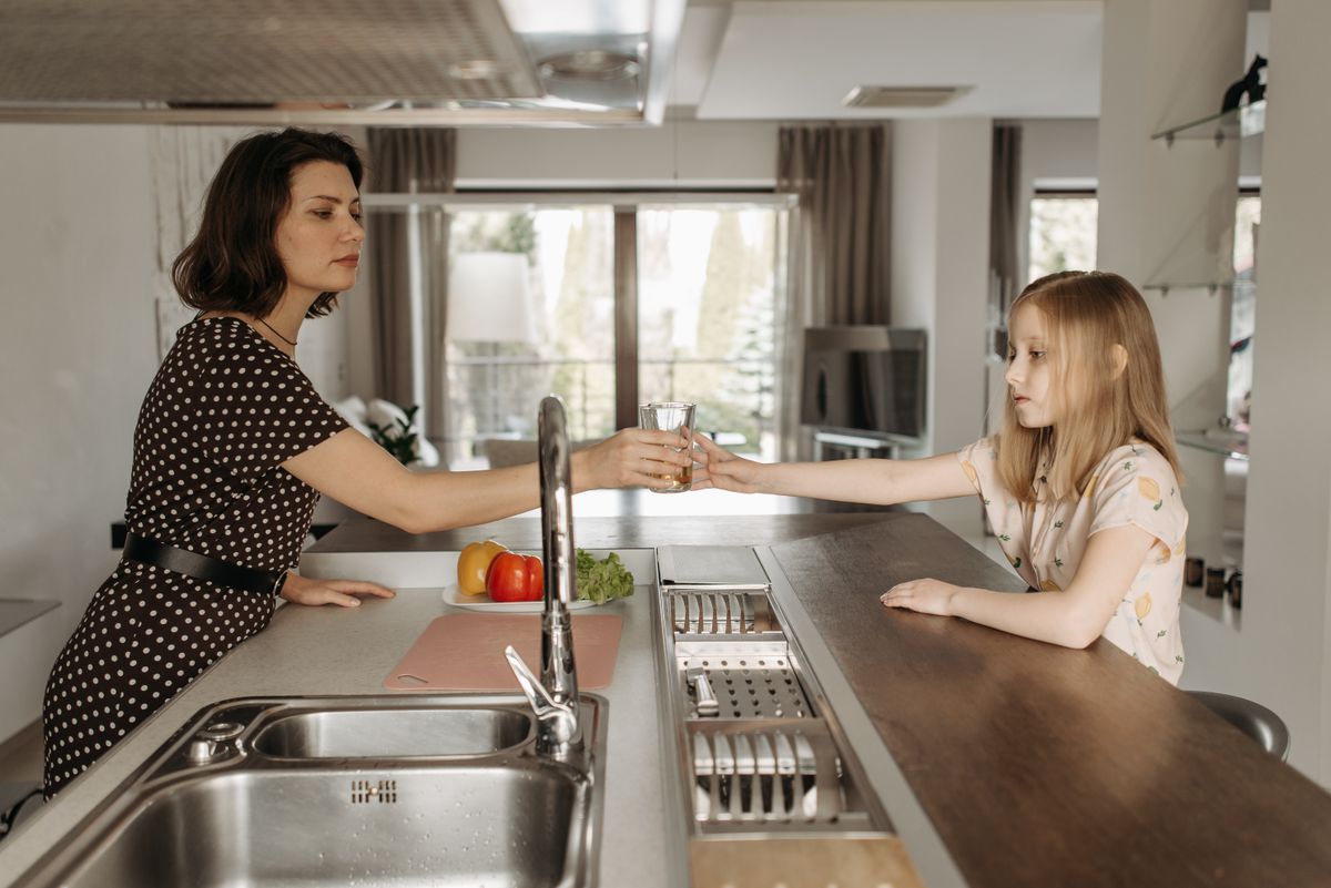 Mother and daughter enjoying a glass of clean, treated drinking water in a Jacksonville home