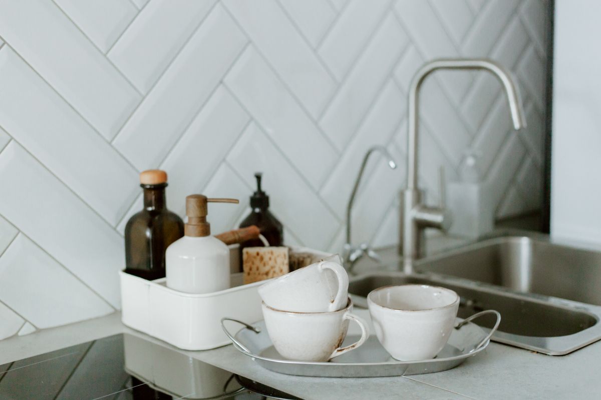Sink with filtered-water dispensers delivering whole-home coverage at every tap