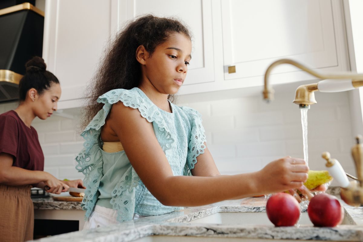 Fresh fruit being rinsed under clean, treated tap water