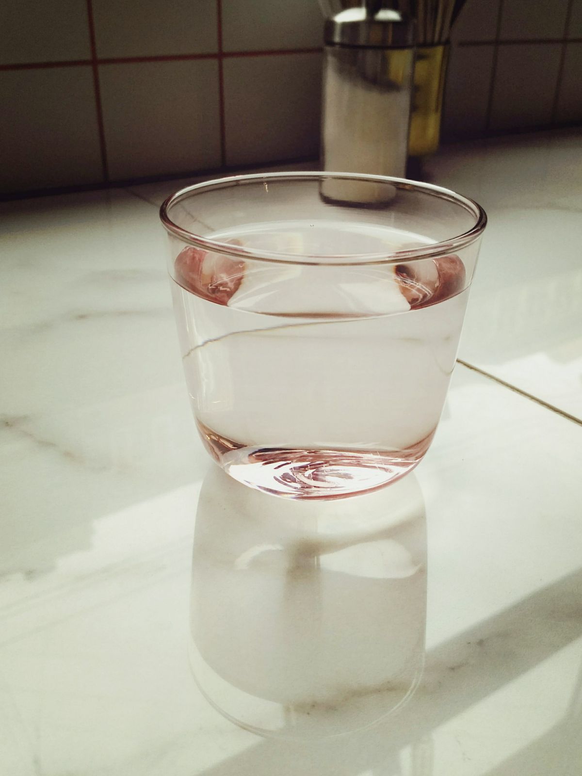 A clean glass of treated water on the counter — a free in-home test shows exactly what is in your water