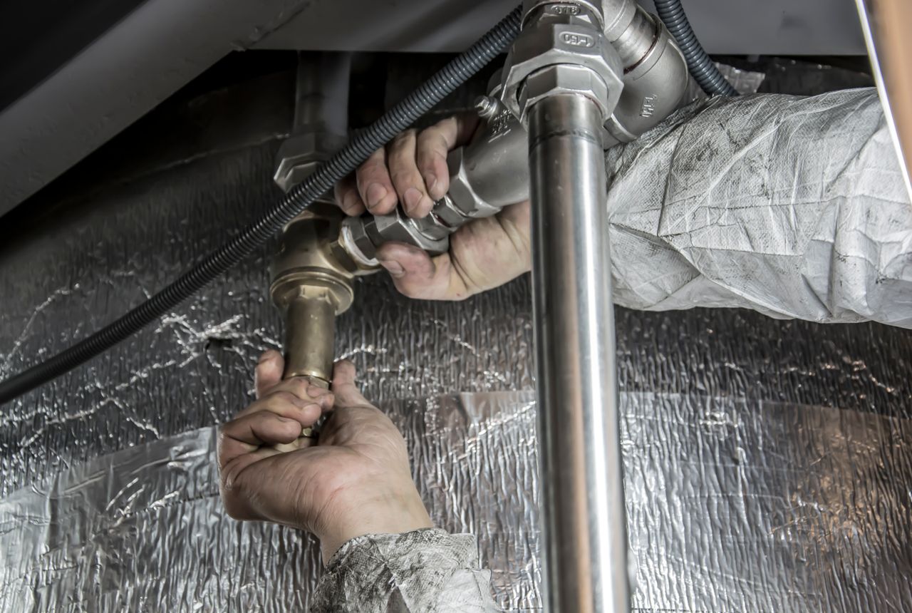 A Waterboy Jax professional installing a Kenai water treatment system in a Jacksonville home