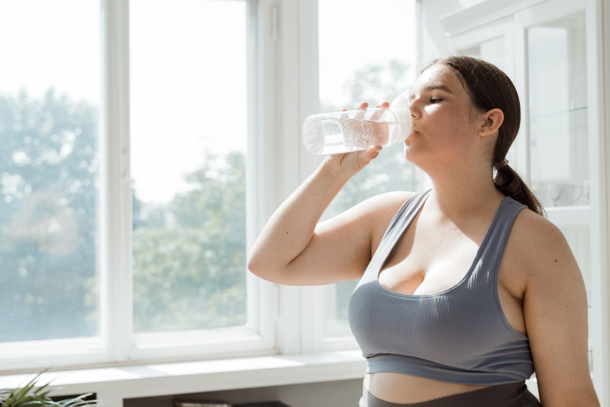 A woman drinking soft, treated water after exercising in a Jacksonville home